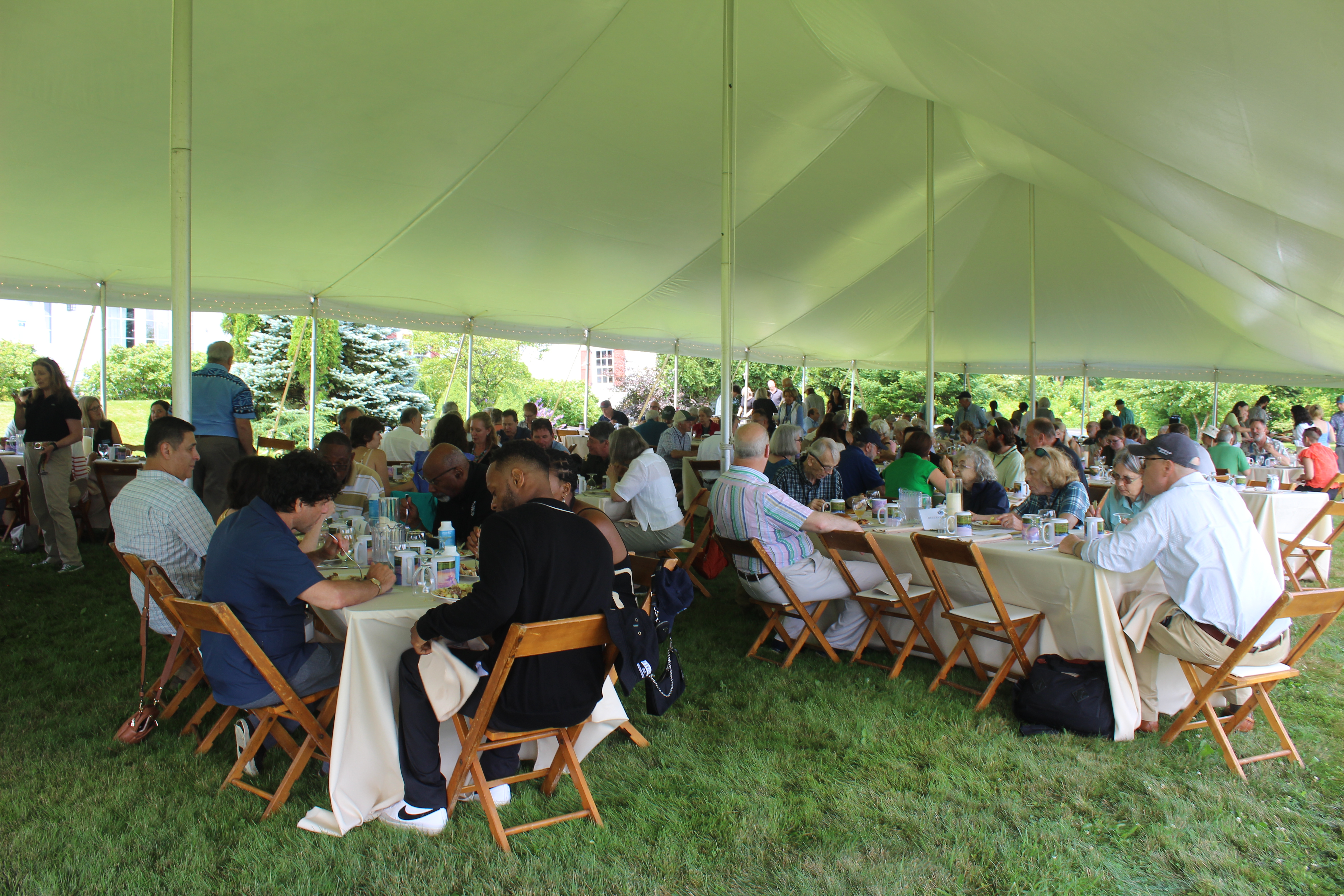 A large crowd enjoys lunch under the tent at Heaven Hill