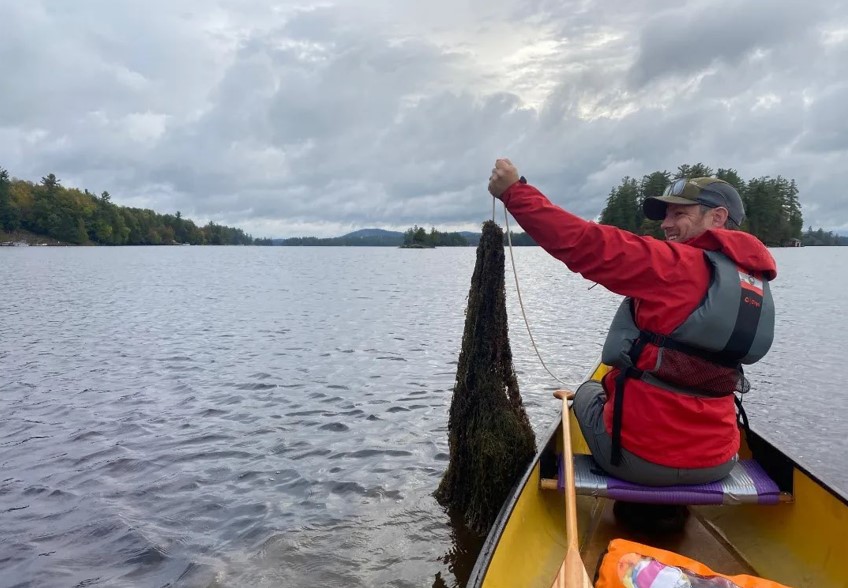 Pulling up a massive growth of invasive milfoil