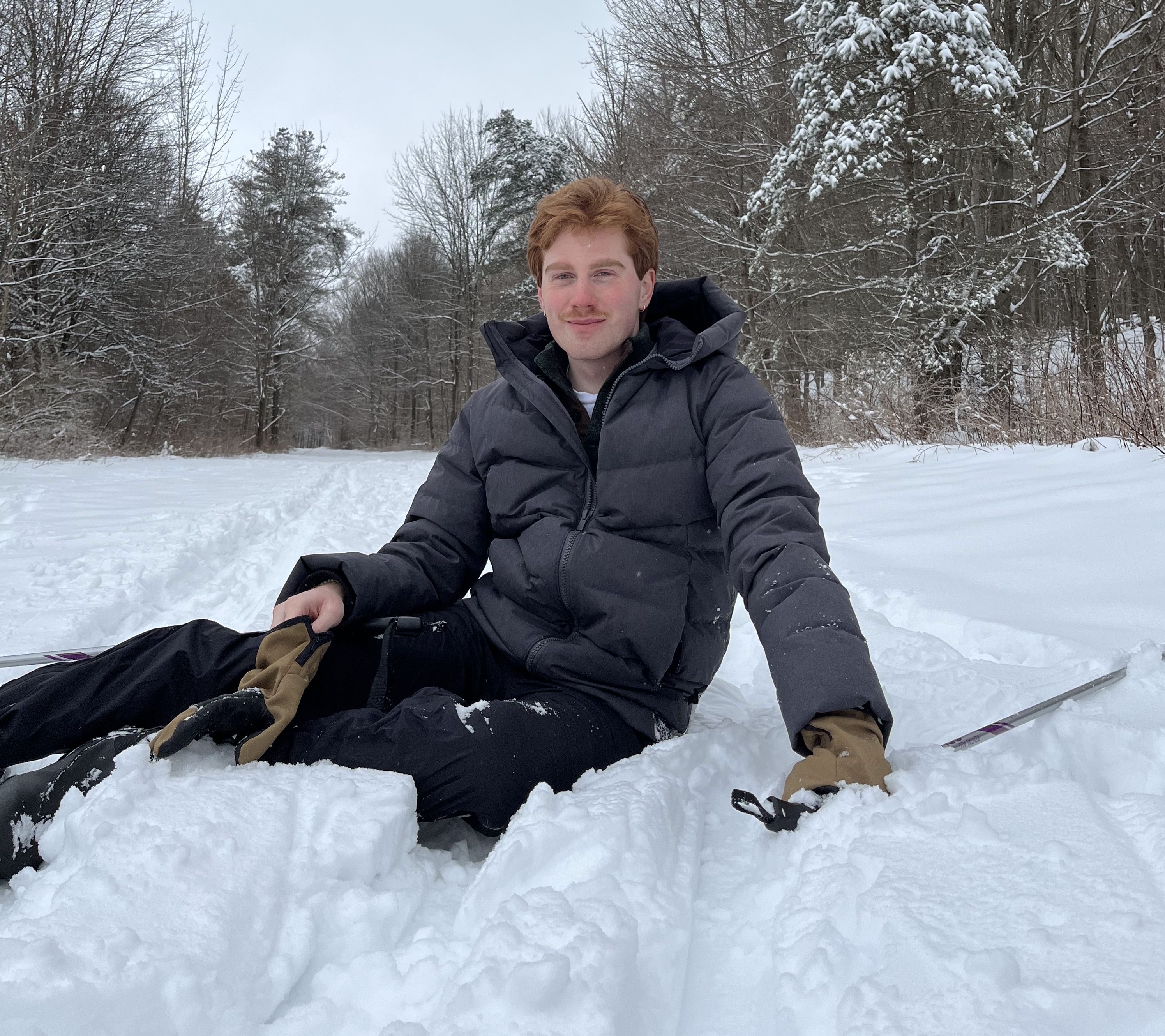 Zach laying in the snow